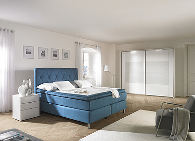 Stimmiges Schlafzimmer in weiß und blau